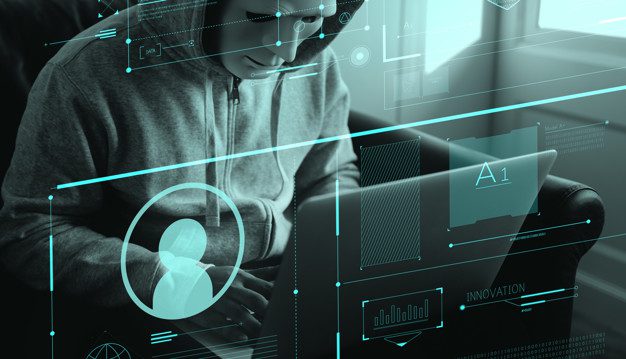 Anonymous hacker committing a computer crime