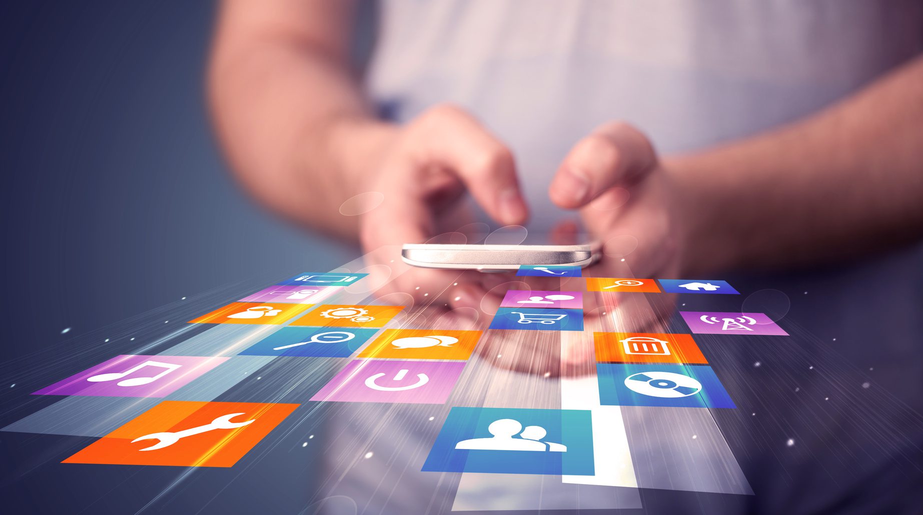 Man holding smart phone with colorful application icons